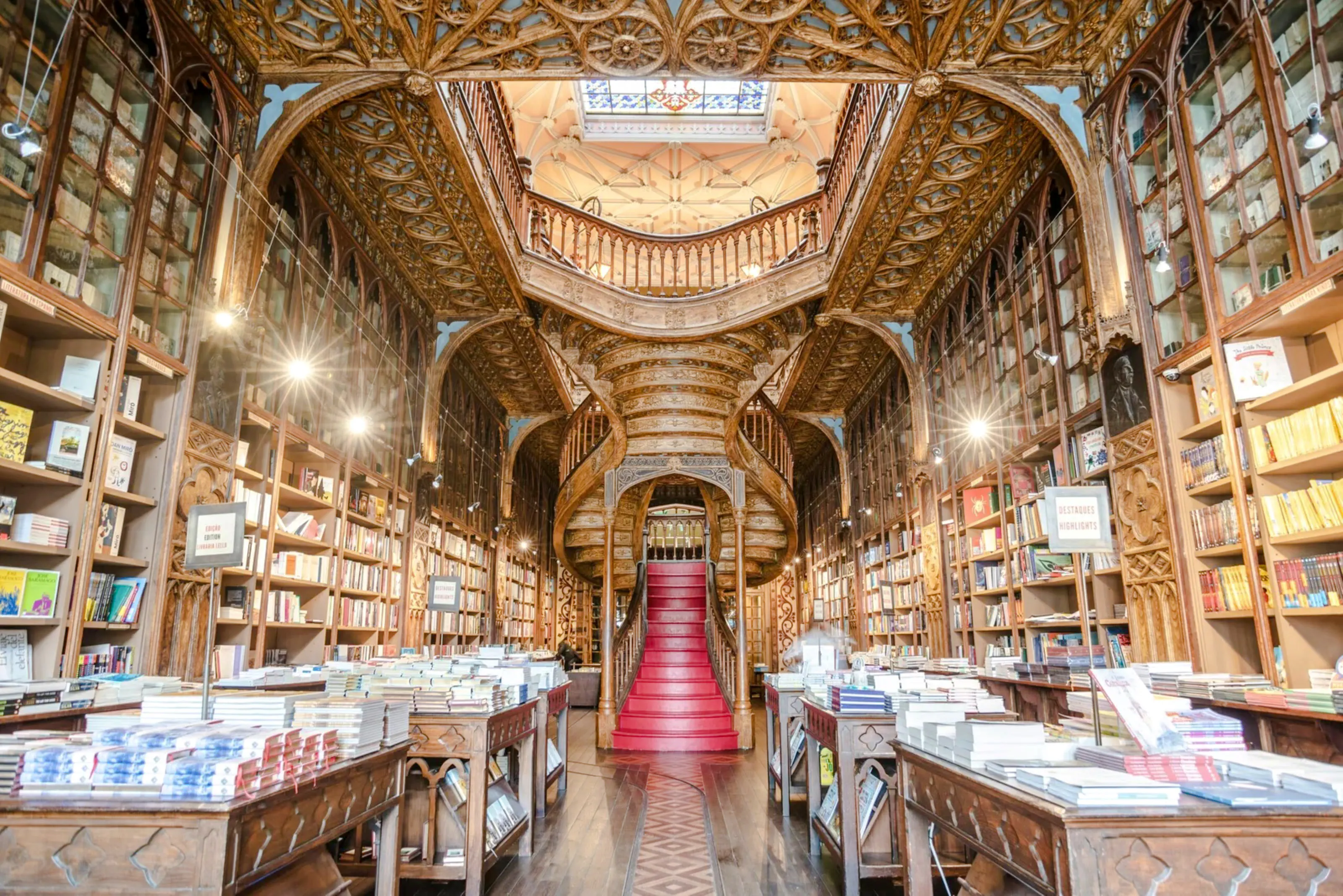 Livraria Lello interior with ornate wooden staircase and bookshelves, Porto.