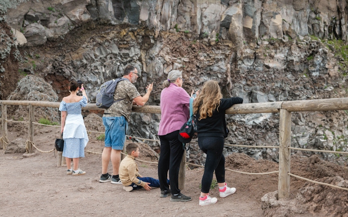 Visitors observing the crater at Mount Vesuvius, Italy.