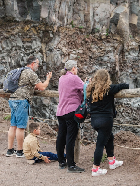 Visitors observing the crater at Mount Vesuvius, Italy.