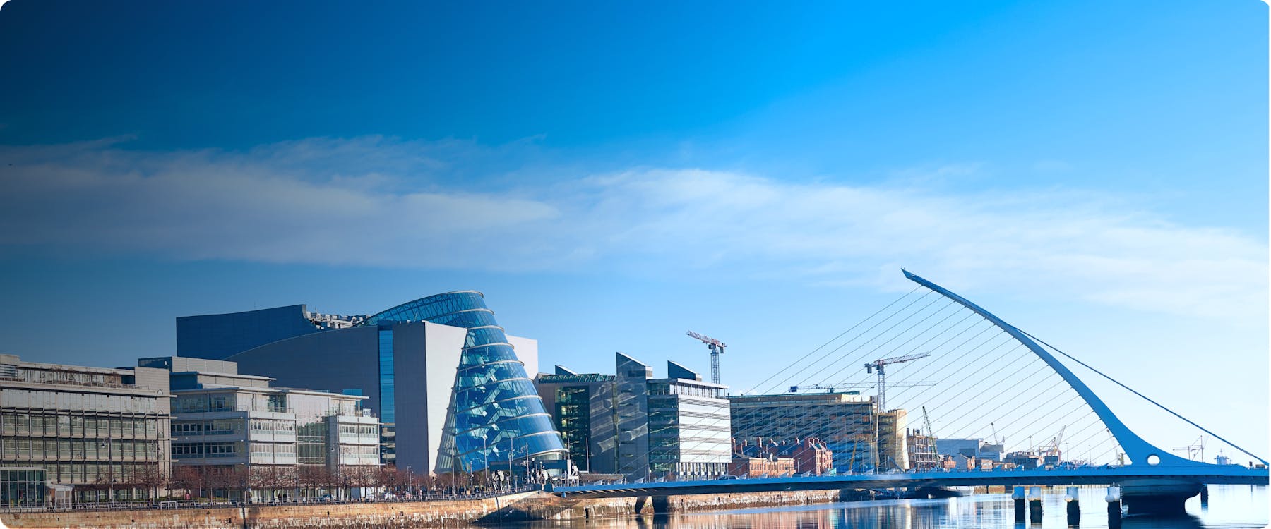 Samuel Beckett Bridge and modern buildings along the River Liffey in Dublin.