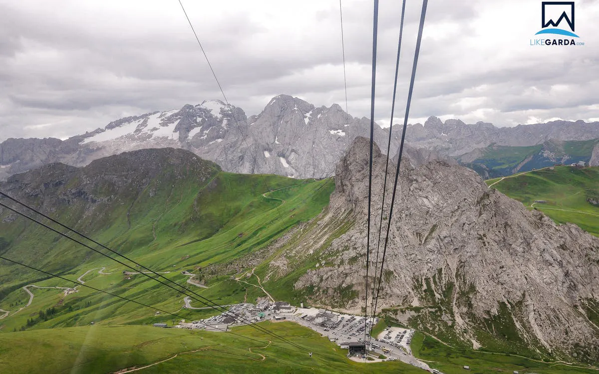 Cable car view of the Dolomites' green valleys and rocky peaks on a guided tour from Verona.