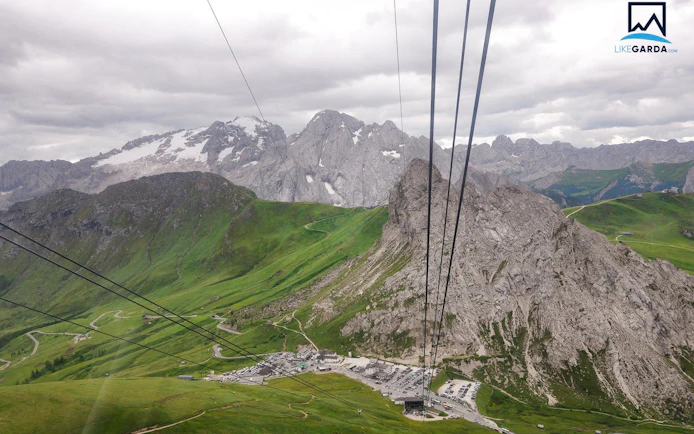 Cable car view of the Dolomites' green valleys and rocky peaks on a guided tour from Verona.