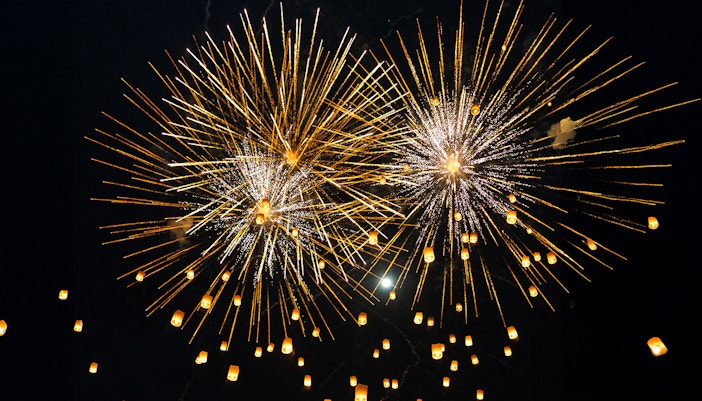 Fireworks and lanterns illuminate the night sky during Yi Peng and Loy Krathong Festival 2025.