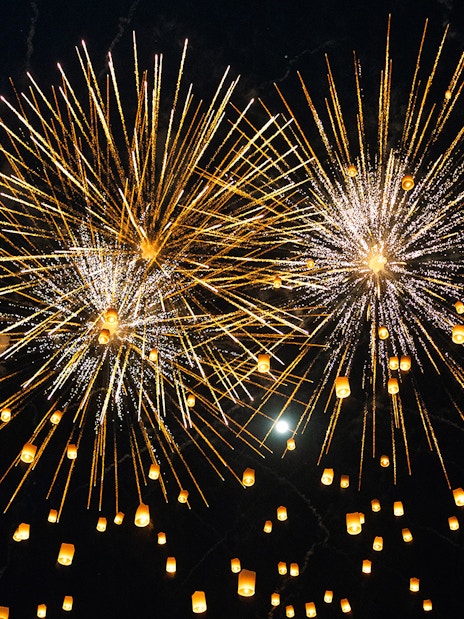 Fireworks and lanterns illuminate the night sky during Yi Peng and Loy Krathong Festival 2025.