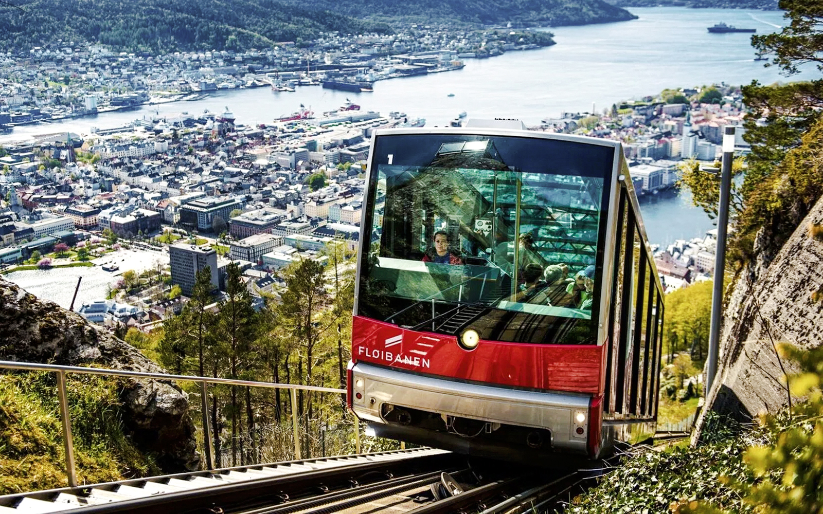 Funicular ascending Mount Floyen with Bergen cityscape in background, Norway.