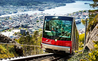 Funicular ascending Mount Floyen with Bergen cityscape in background, Norway.