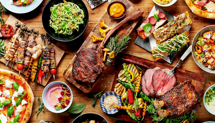 Buffet spread with grilled meats, salads, and bread at Gastronomy Buffet Dinner, Dubai.