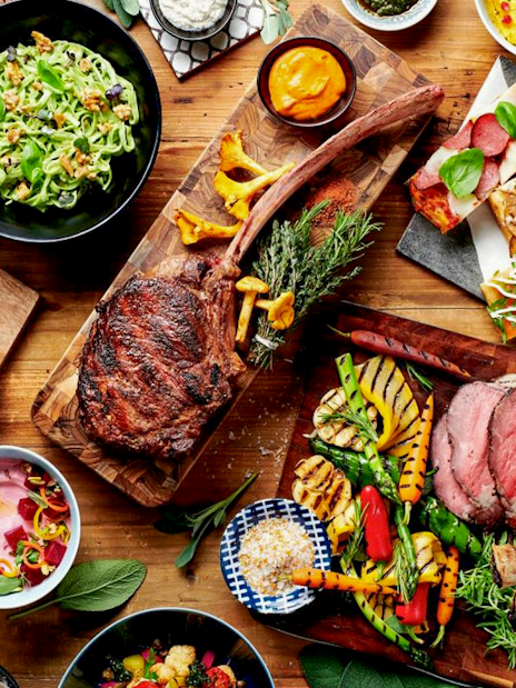 Buffet spread with grilled meats, salads, and bread at Gastronomy Buffet Dinner, Dubai.