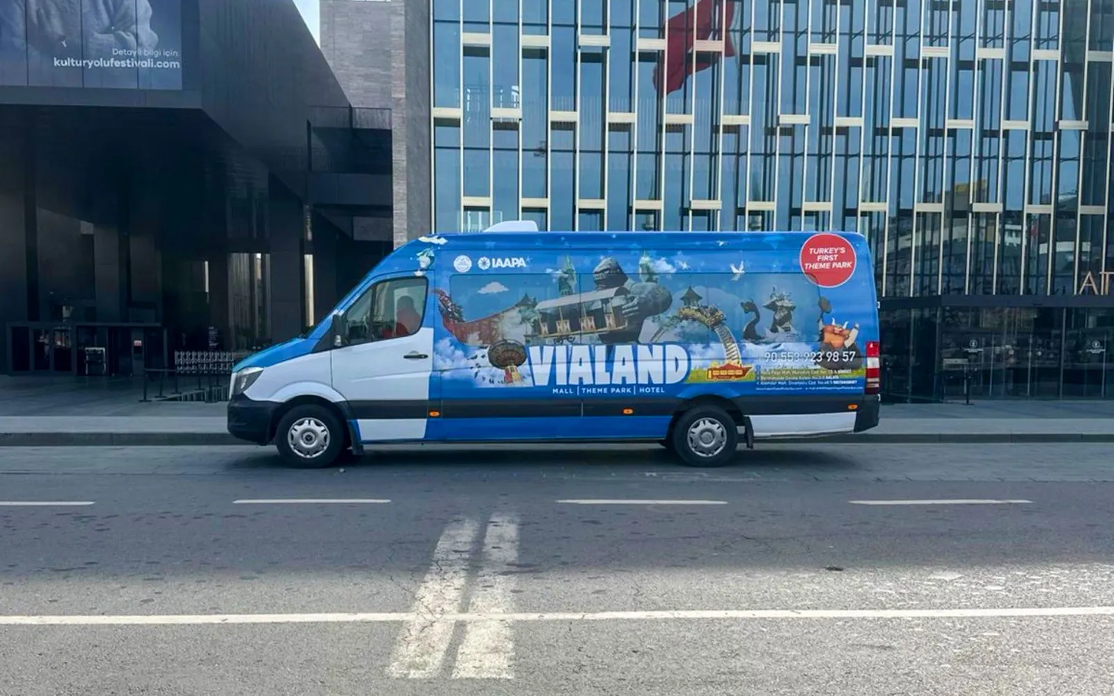 Shuttle bus for Vialand Theme Park in Istanbul parked on a city street.