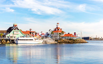 Shoreline Village in Rainbow Harbor with colorful buildings and a docked boat.