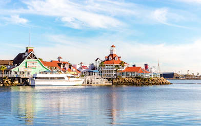 Shoreline Village in Rainbow Harbor with colorful buildings and a docked boat.