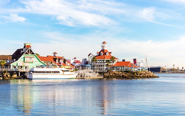 Shoreline Village in Rainbow Harbor with colorful buildings and a docked boat.