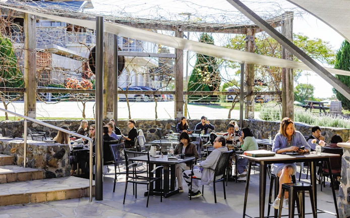 Visitors dining outdoors at Sirromet Winery, Gold Coast.