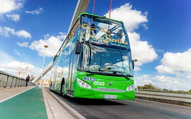Sevilla tour bus crossing a bridge in Seville, Spain.