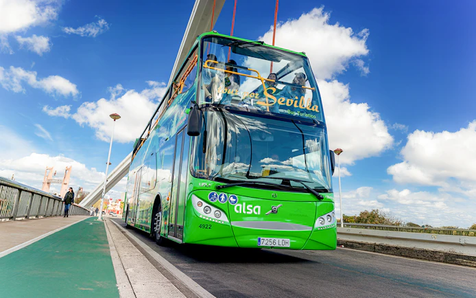 Sevilla tour bus crossing a bridge in Seville, Spain.