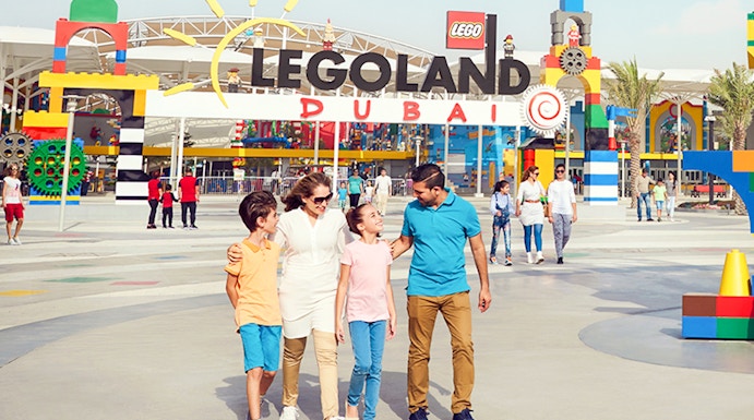 Family walking at Legoland Dubai entrance in Dubai Parks and Resorts.
