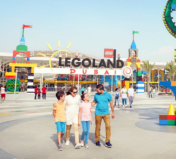 Family walking at Legoland Dubai entrance in Dubai Parks and Resorts.
