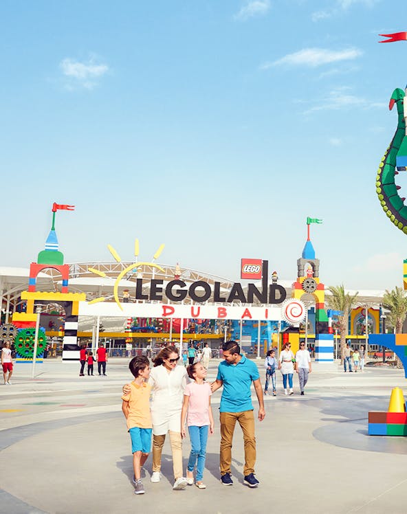 Family walking at Legoland Dubai entrance in Dubai Parks and Resorts.