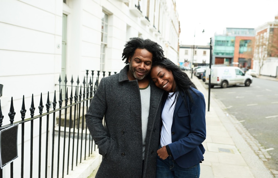 Couple enjoying a romantic walk on a London street during Valentine's Day tour.