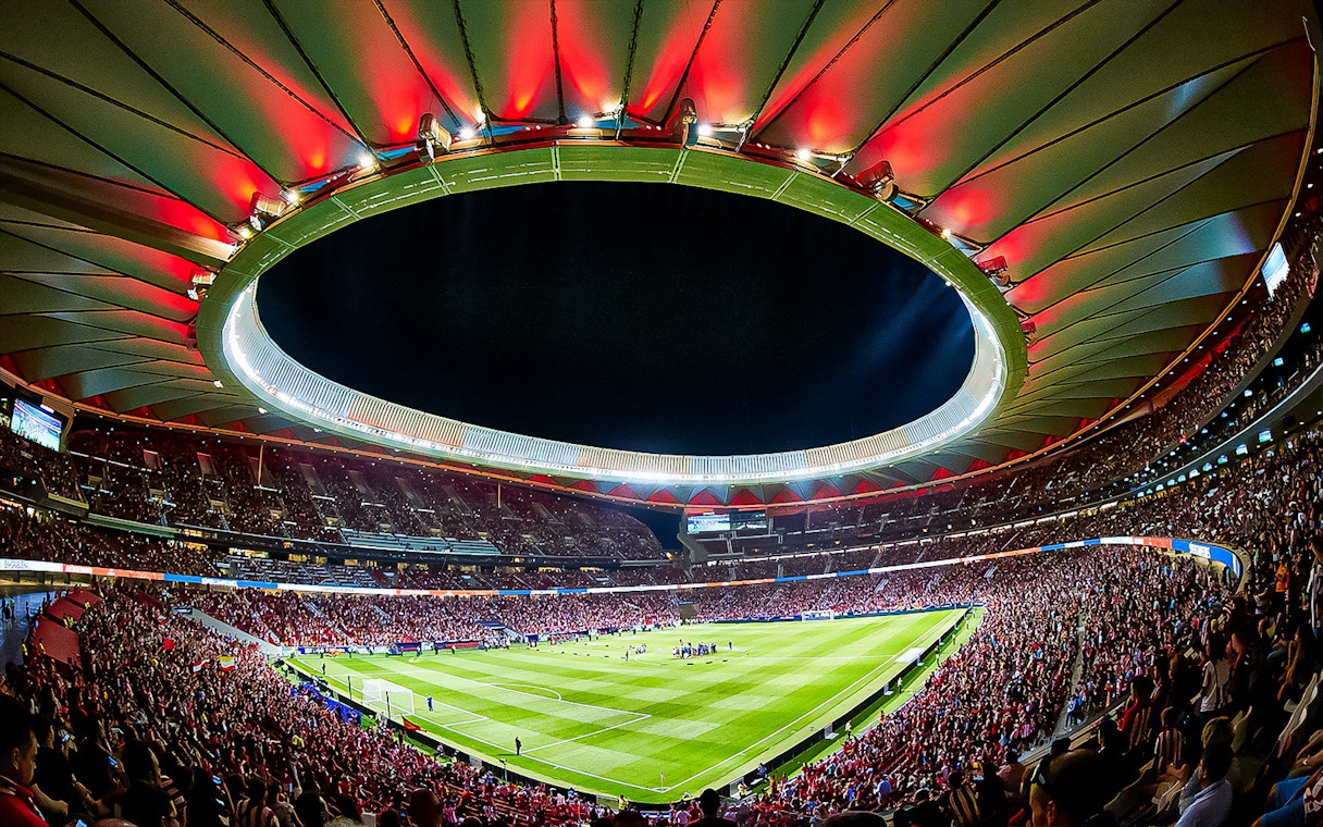 Atletico de Madrid Stadium filled with spectators during a night event.