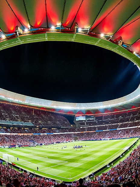 Atletico de Madrid Stadium filled with spectators during a night event.