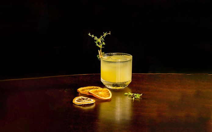 Cocktail with garnish and dried citrus slices at CÉ LA VI Dubai.