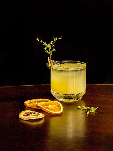 Cocktail with garnish and dried citrus slices at CÉ LA VI Dubai.