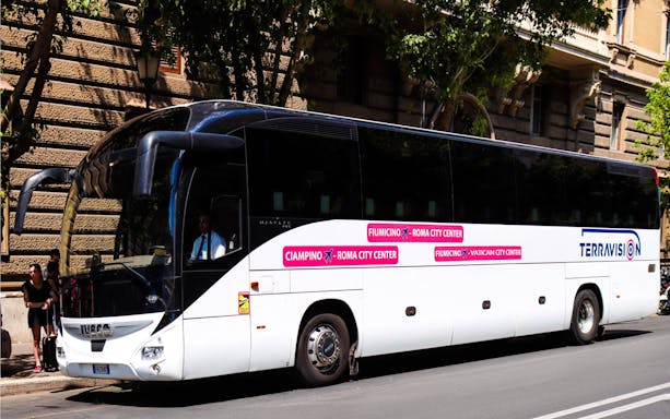Terravision bus for Fiumicino Airport transfer parked on a city street.
