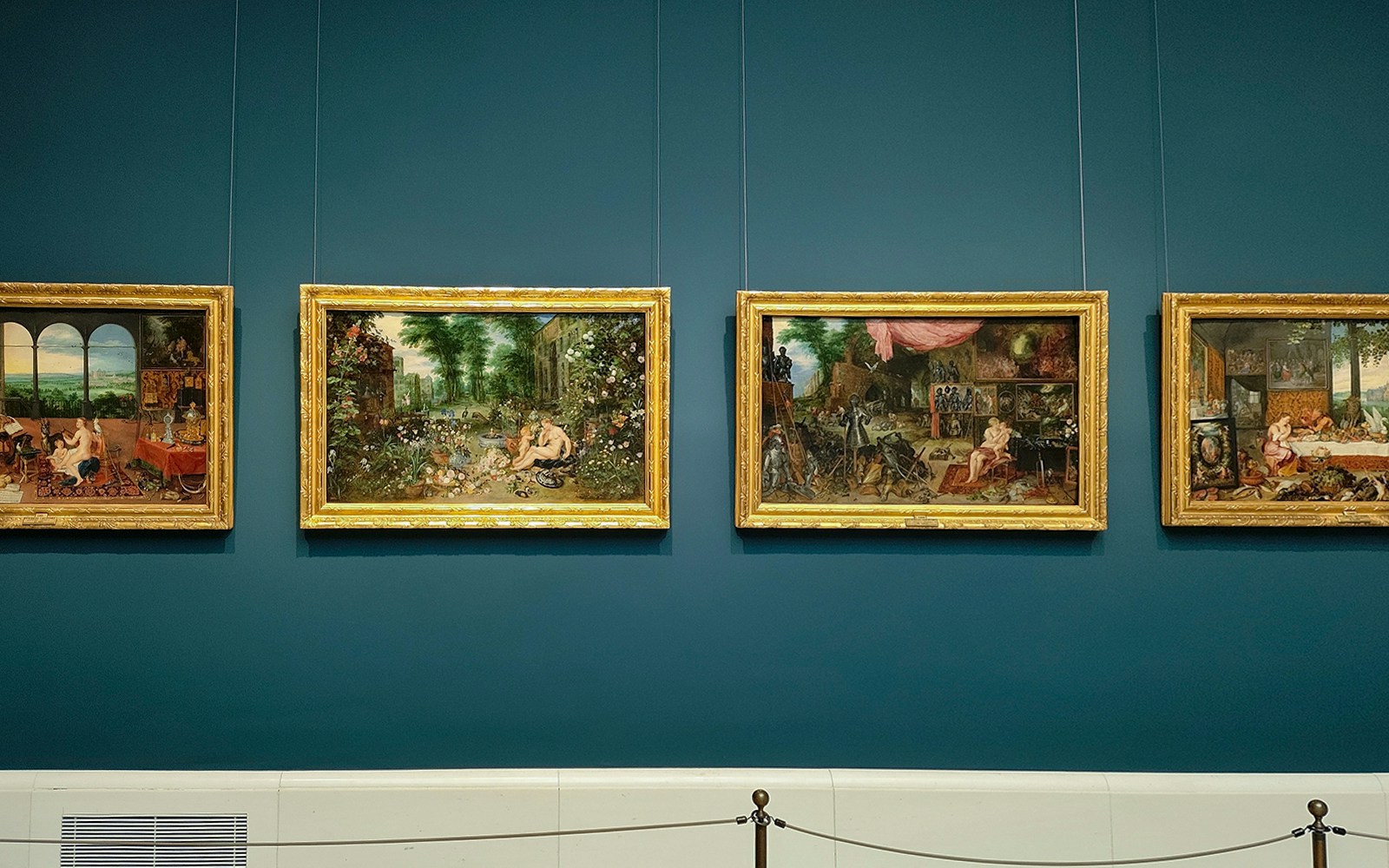 Visitors viewing art at Prado Museum, Madrid, with entry tickets.