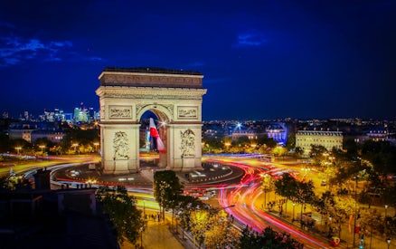 Arc de Triomphe illuminated at night during Paris Illumination Tour.