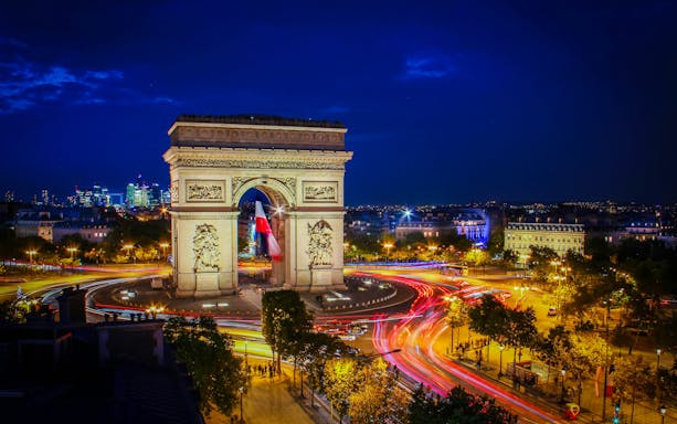 Arc de Triomphe illuminated at night during Paris Illumination Tour.