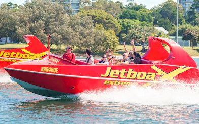 Jet boat with passengers enjoying a thrilling ride on the water.