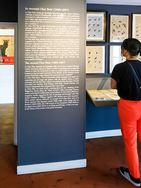 Woman reading exhibit information at Museum of Montmartre, Paris.