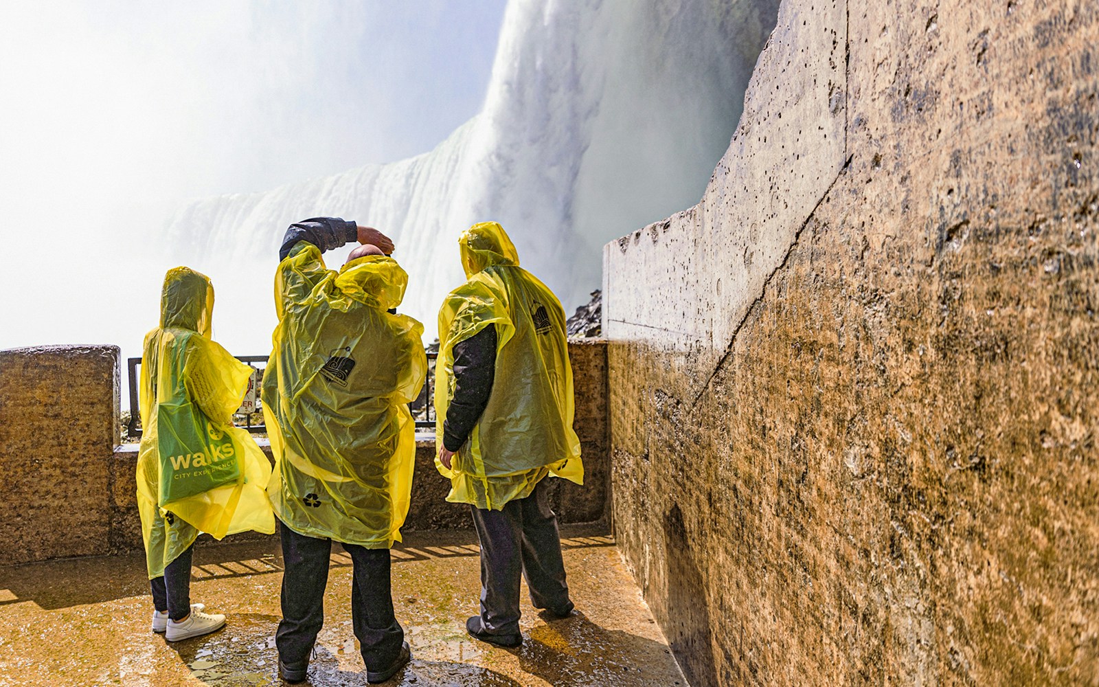 Tourists experiencing Journey Behind the Falls at Niagara Falls