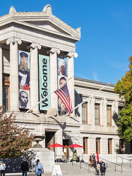 Museum of Fine Arts Boston entrance with banners and visitors.