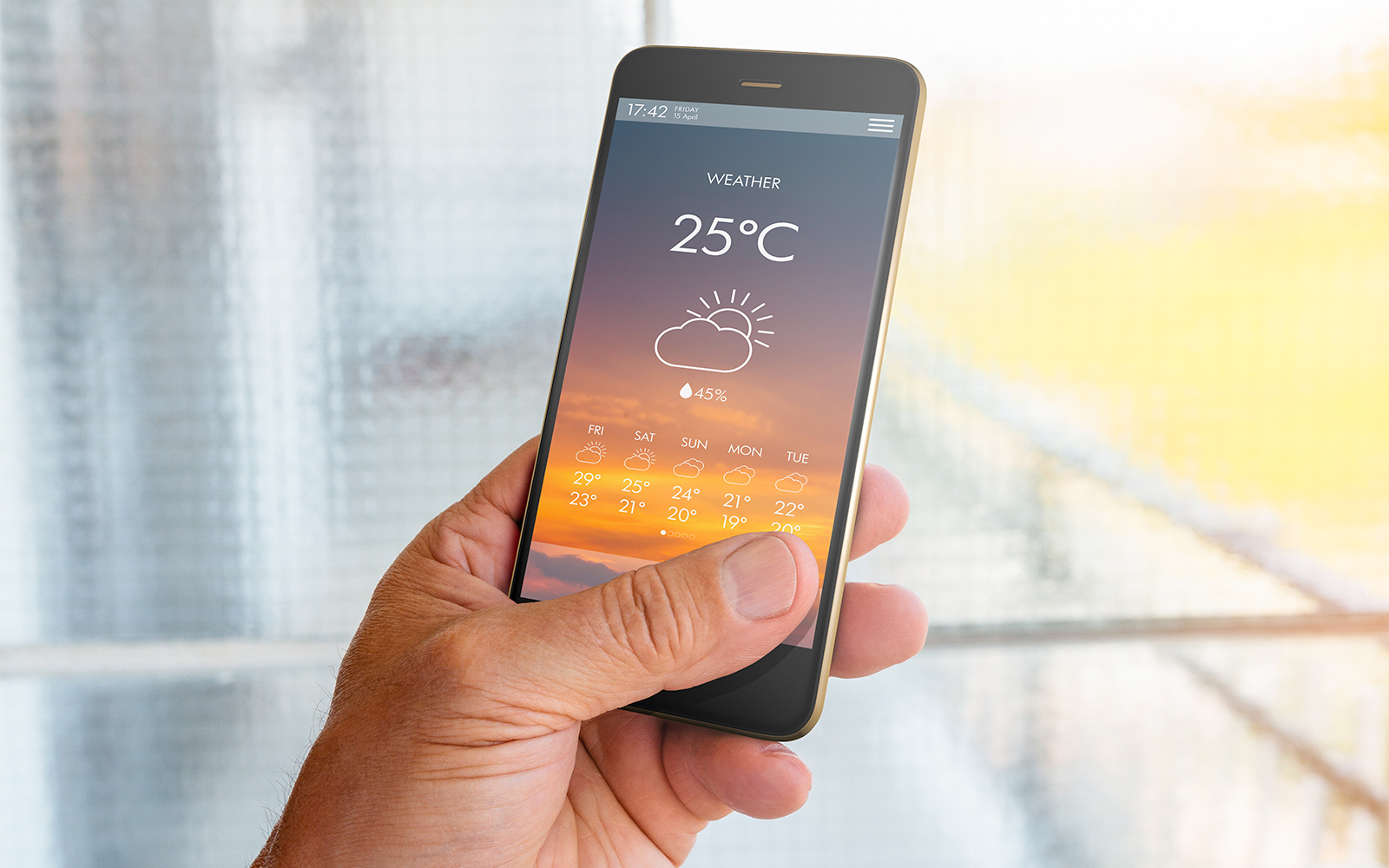 Smartphone displaying weather forecast, relevant for tandem skydive planning.