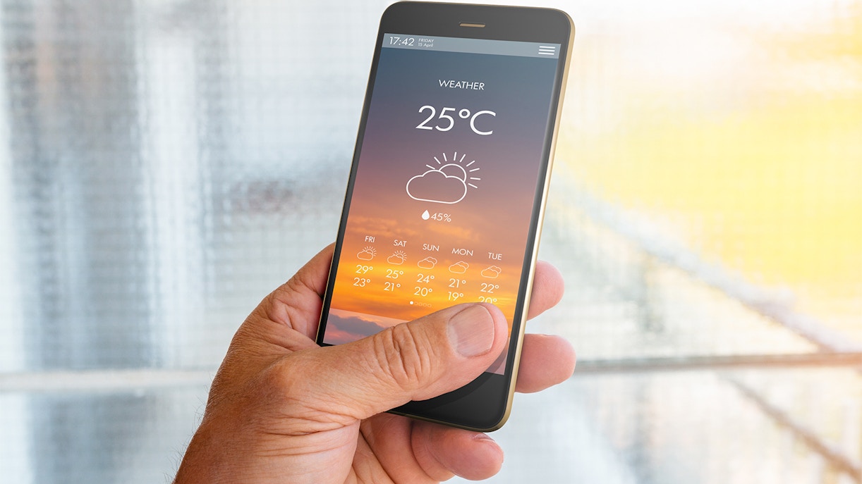 Smartphone displaying weather forecast, relevant for tandem skydive planning.