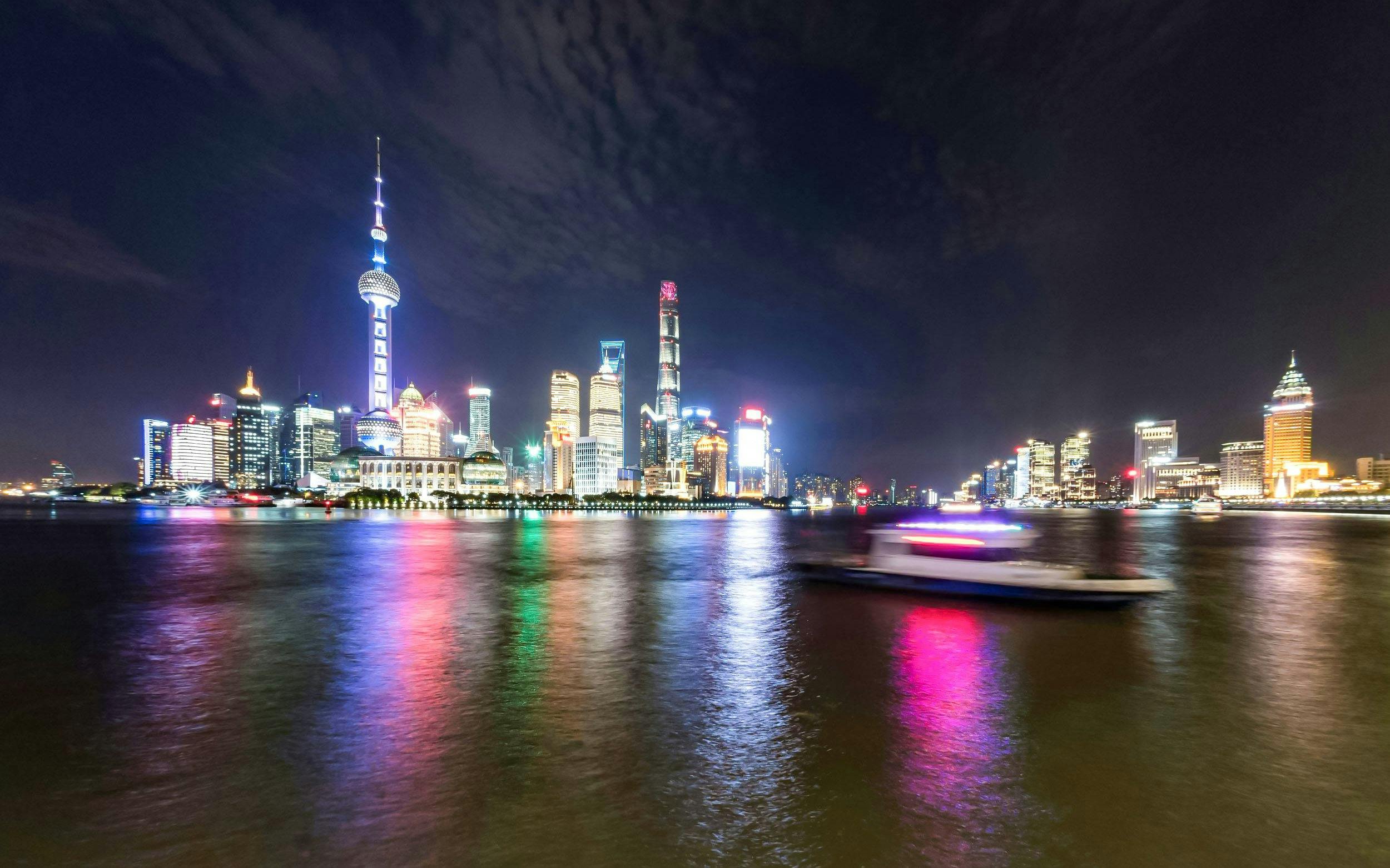 Shanghai skyline at night across Huangpu River from The Bund.