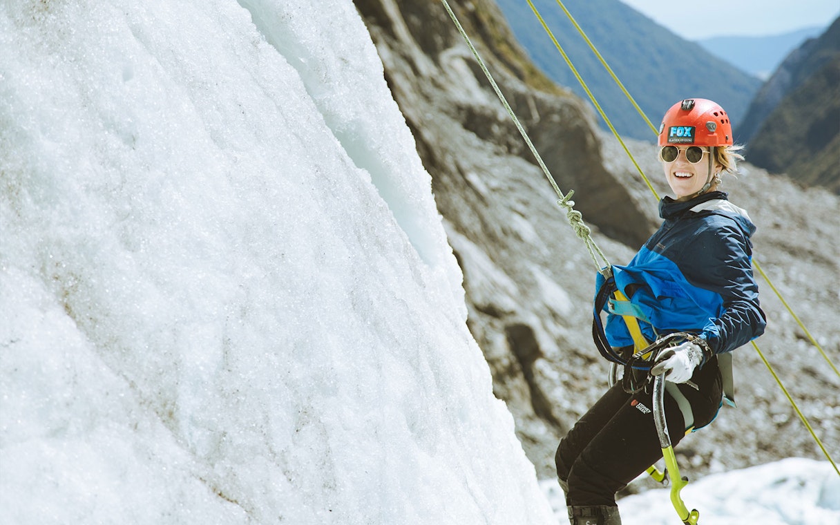 Tourist climbing Fox Glacier during Heli Ice Climbing Experience in New Zealand.
