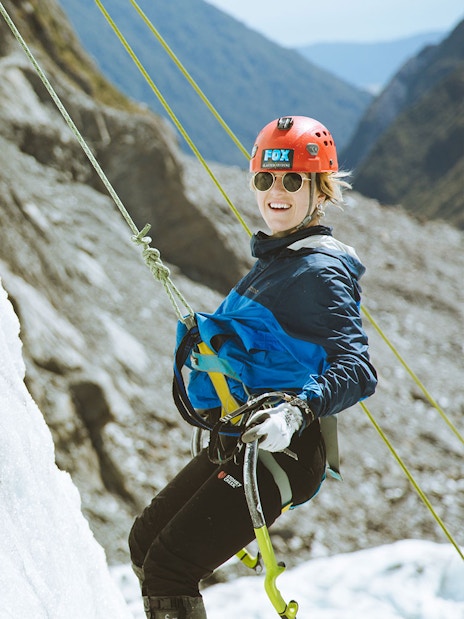 Tourist climbing Fox Glacier during Heli Ice Climbing Experience in New Zealand.
