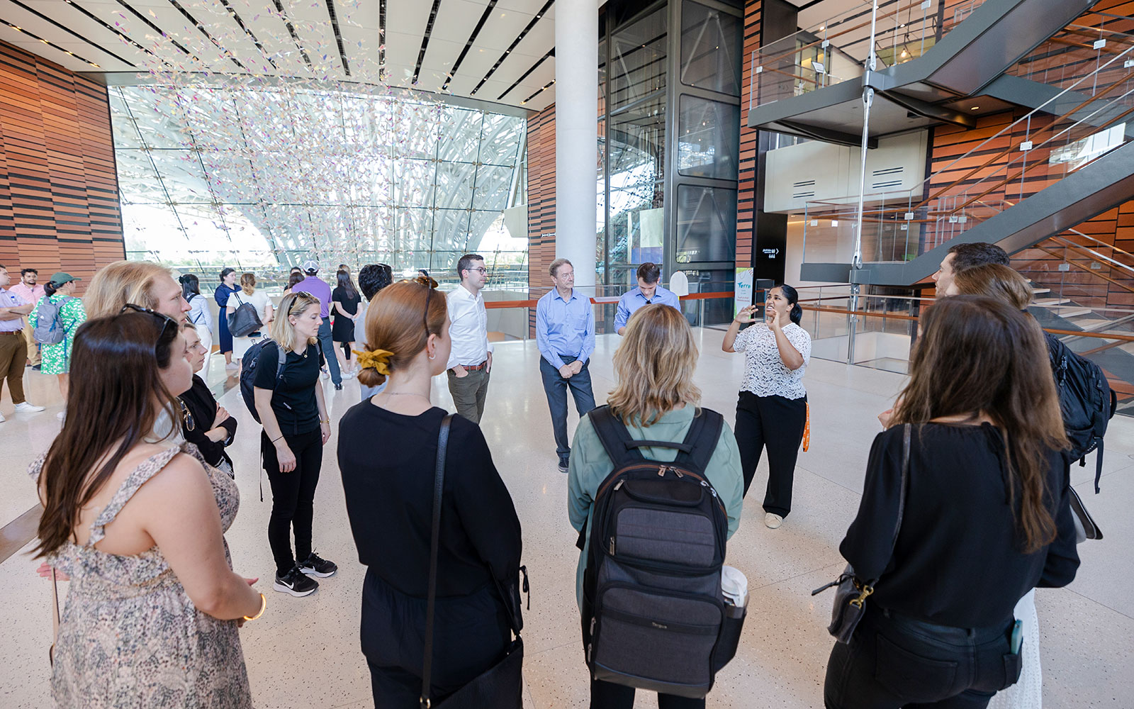 Guide engaging with tourists inside Expo City Dubai.