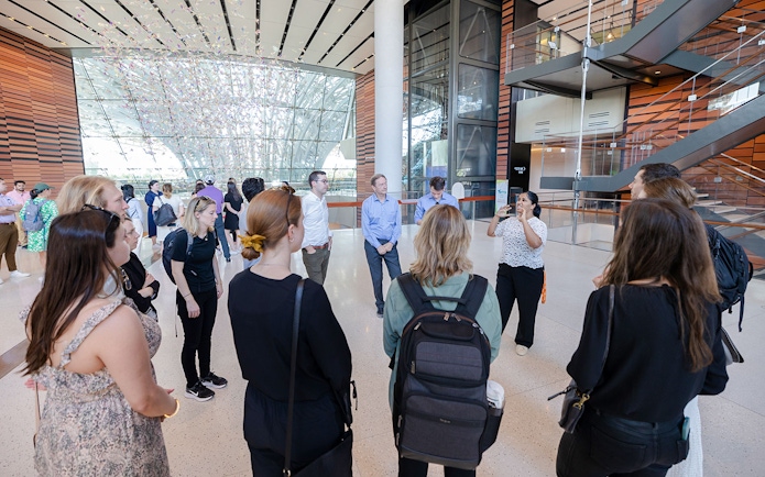 Guide engaging with tourists inside Expo City Dubai.
