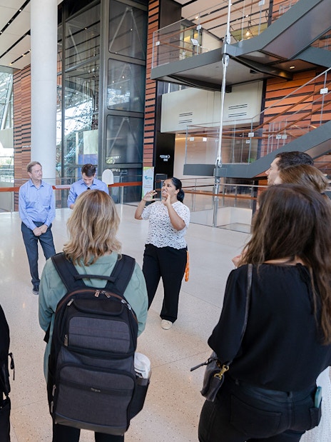 Guide engaging with tourists inside Expo City Dubai.
