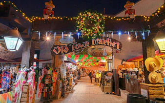 Old Town Market entrance decorated with holiday lights during San Diego's festive nights tour.