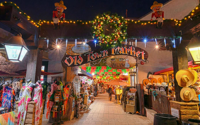 Old Town Market entrance decorated with holiday lights during San Diego's festive nights tour.