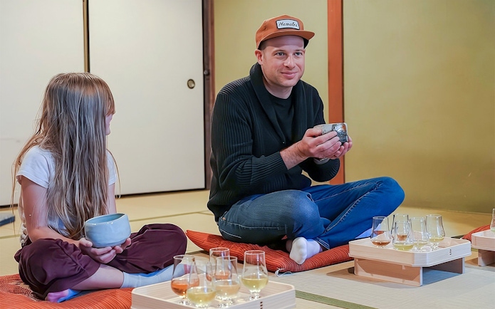 Father and daughter enjoying a private tea ceremony with seasonal wagashi in Japan.