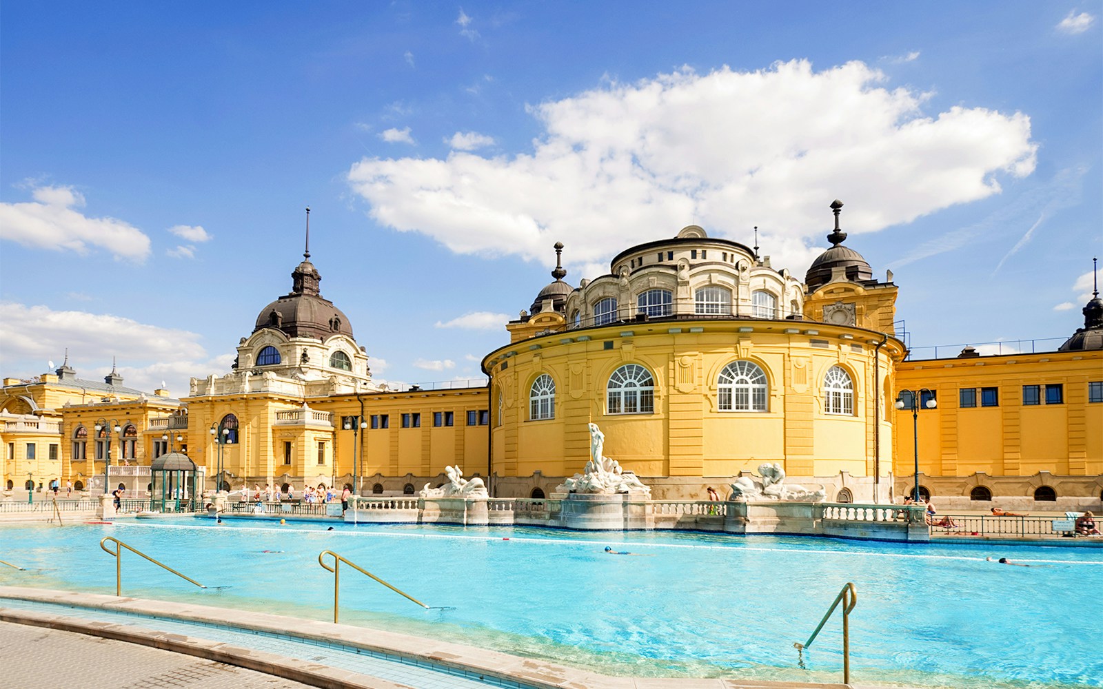 Szechenyi thermal baths in Budapest with people enjoying the outdoor pools.