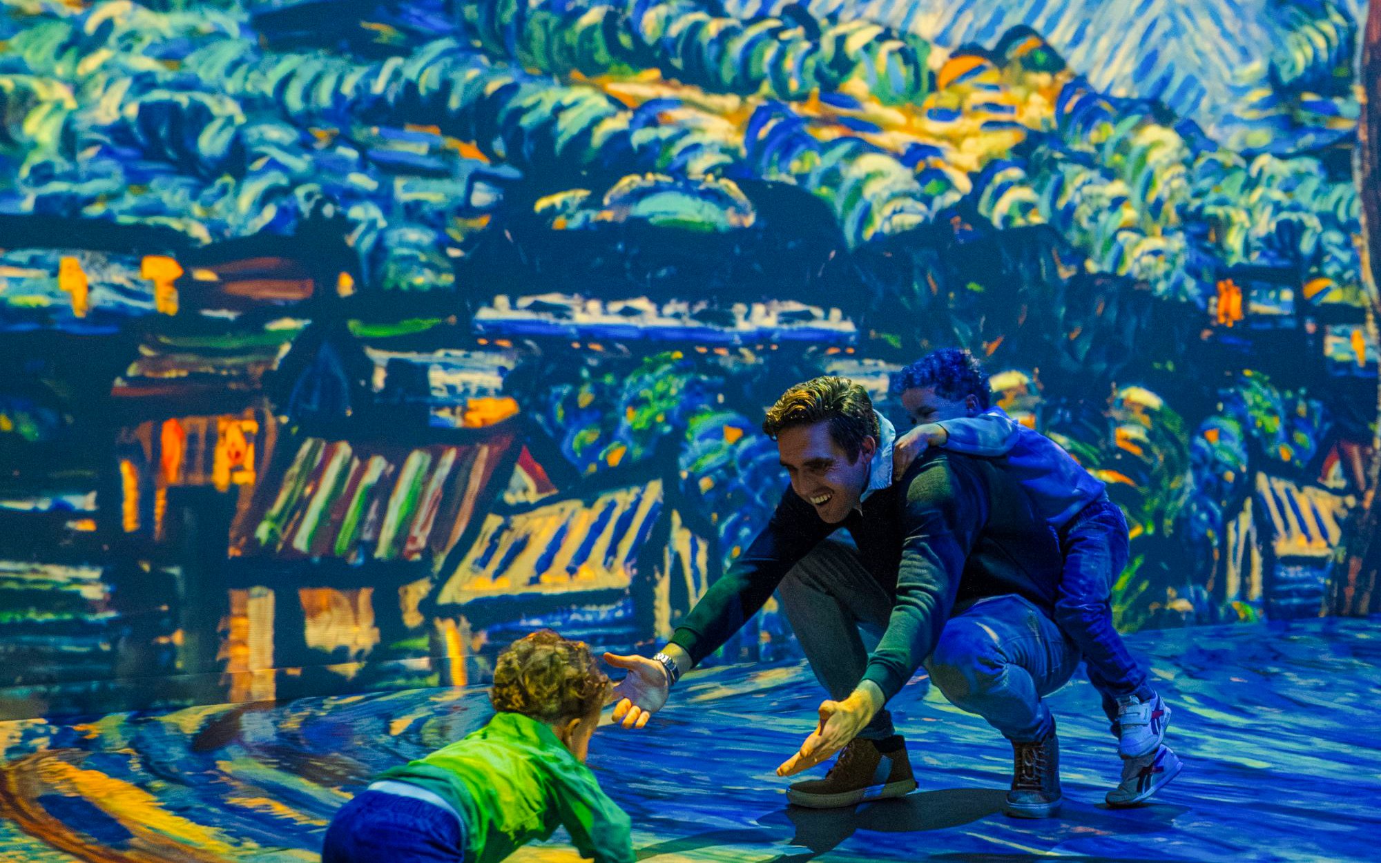 Family enjoying interactive Dutch Masters Exhibition at Fabrique des Lumières.