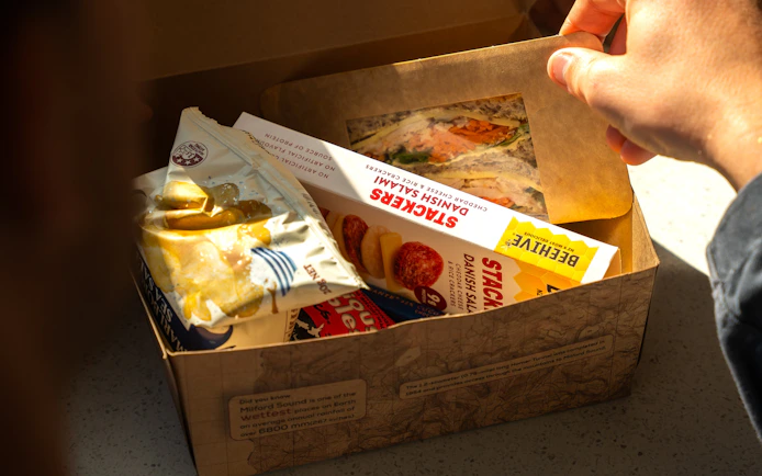 Lunch box with sandwich and snacks on Milford Sound Extended Cruise.