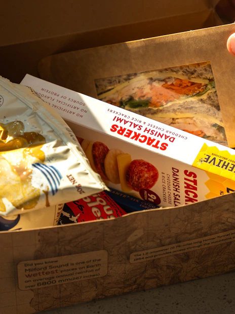 Lunch box with sandwich and snacks on Milford Sound Extended Cruise.